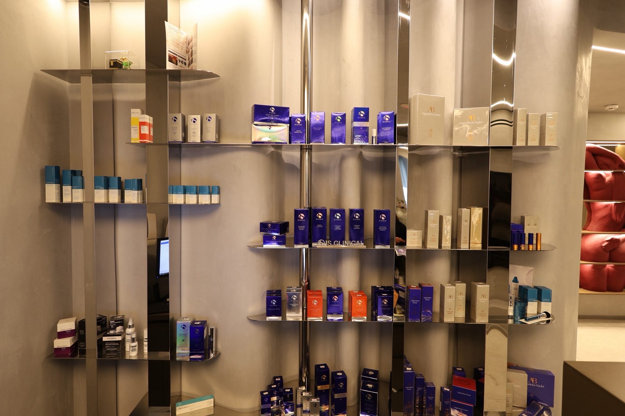 Curved mirror-polished retail wall holding products at reception