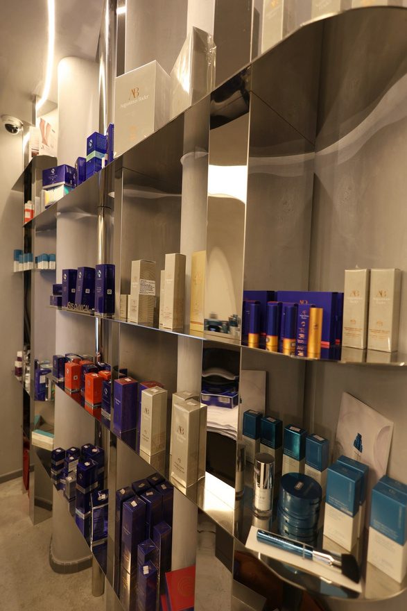 Detail of the polished stainless steel retail wall at Beauty Time