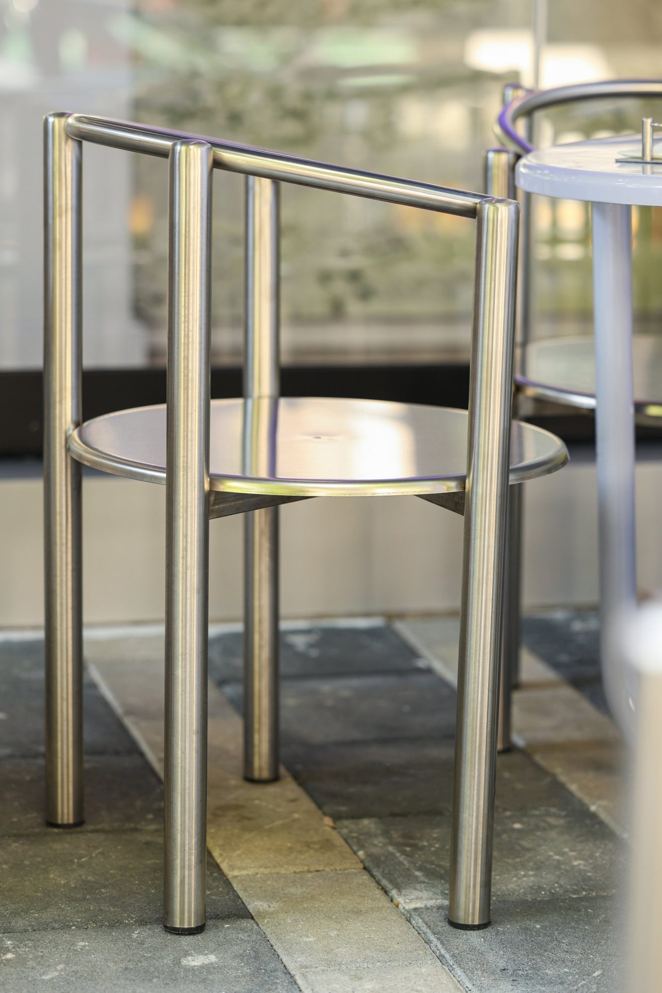Minimal tubular steel chair with a circular seat at Bloom the Matcha