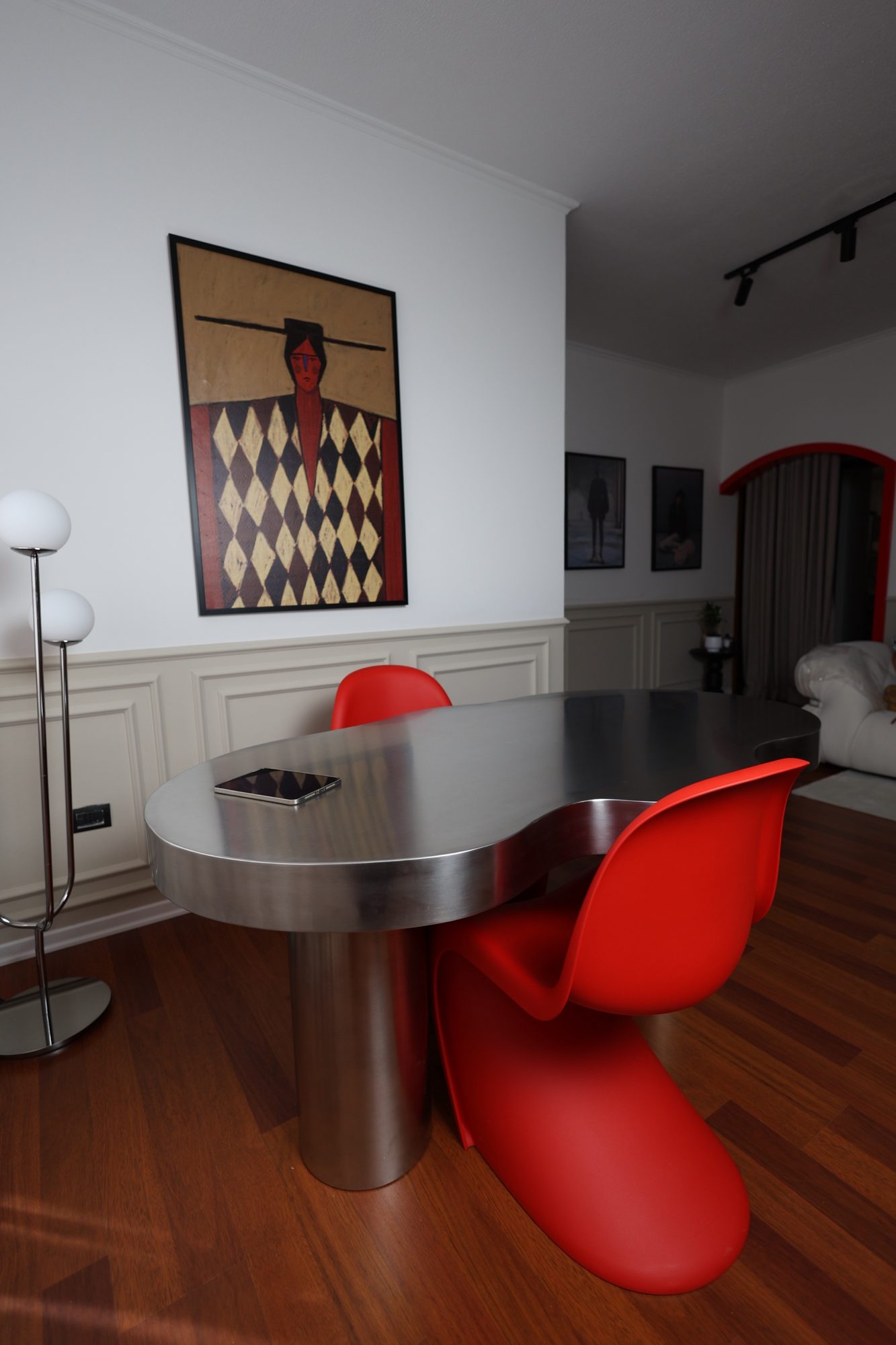Second view of the steel table and red chairs at Door 903