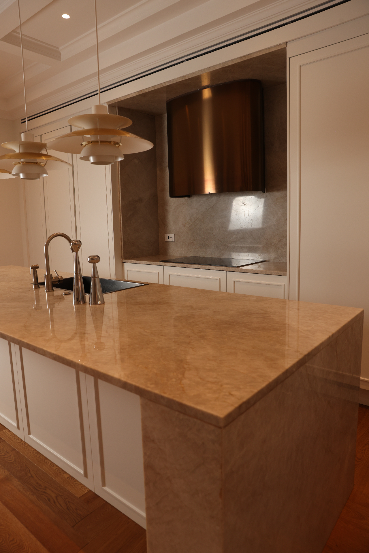 Curved stainless steel kitchen hood set into stone at Villa Allegra