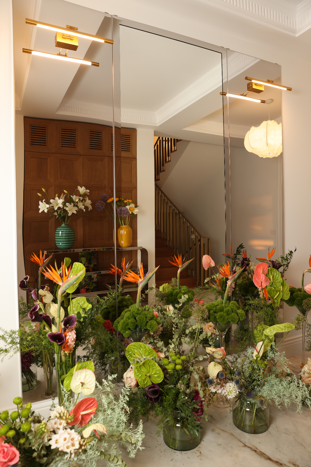 Flowers arranged against a reflective mirror wall