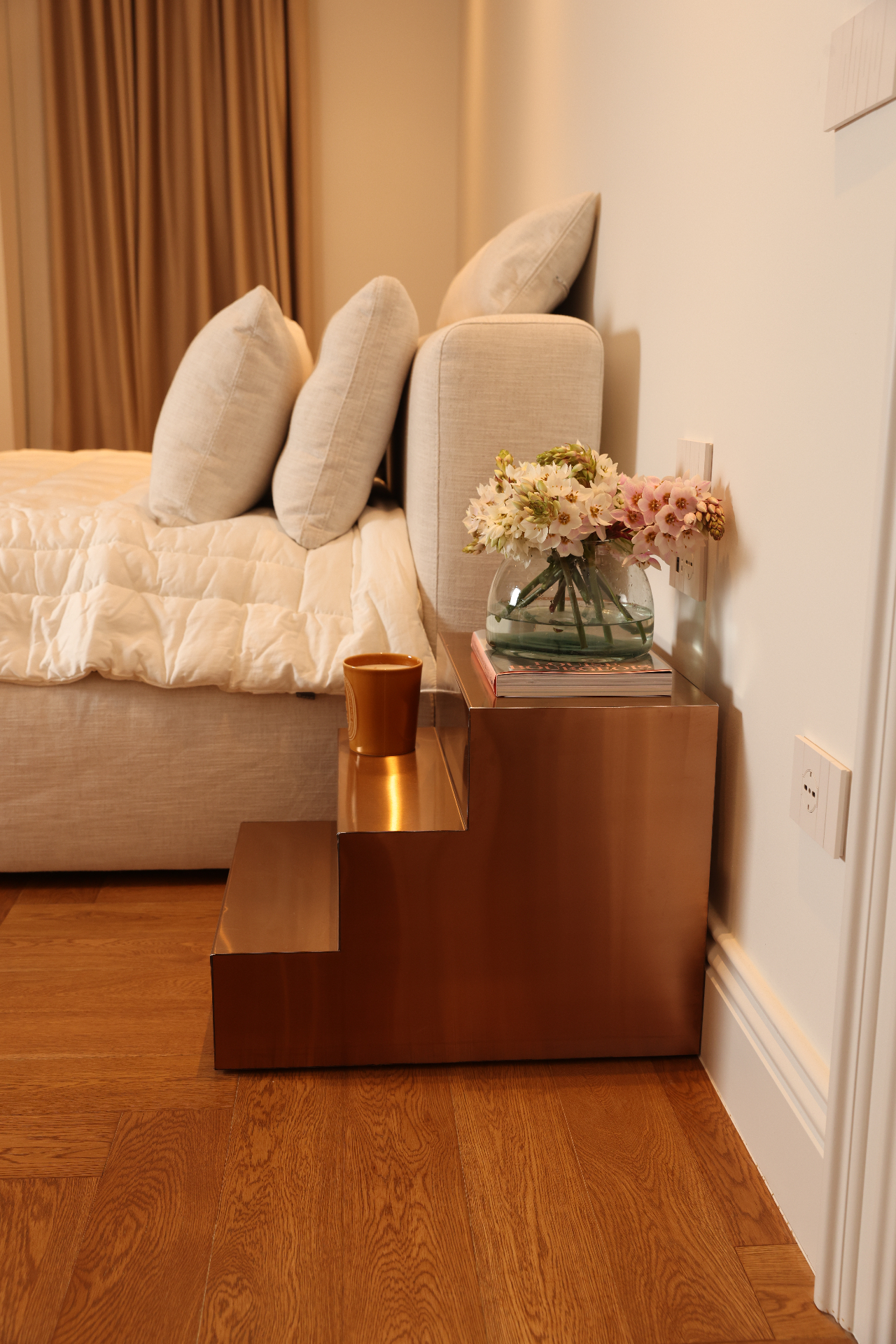 Reflective stainless steel side table formed as a series of steps